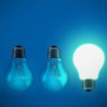 5 lightbulbs on a blue background. 4 of them are facing down and off. One is facing up and on. This is representing how you can get inspo when you run out of ideas.