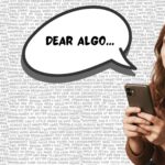 An image of a girl, looking with hope at the sky while looking at her phone and wishing for the algorithm to listen to her plea.